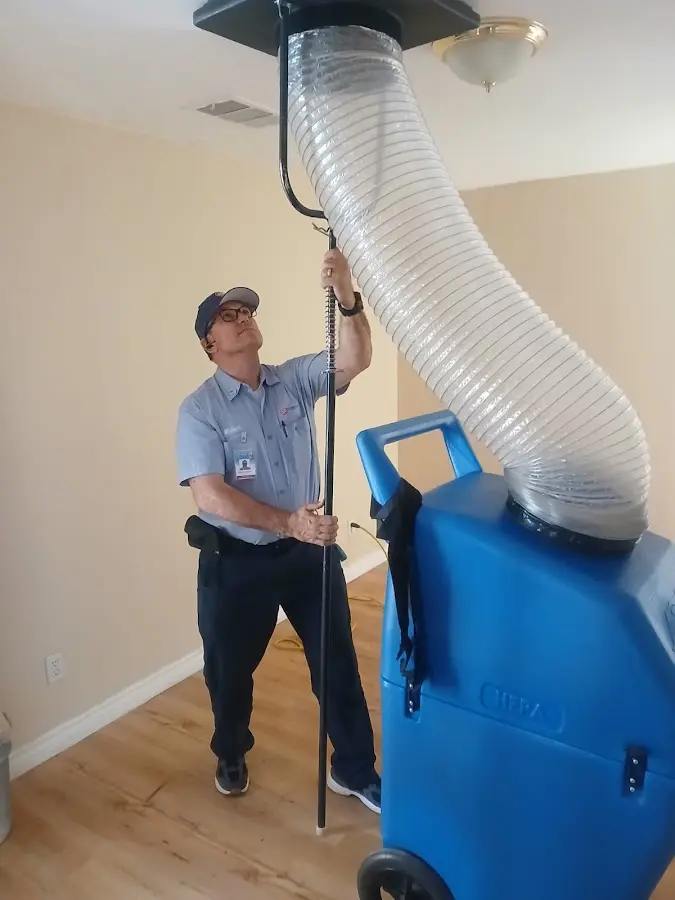Furnace Tune-Up technician using HEPA equipment in Mitchellville
